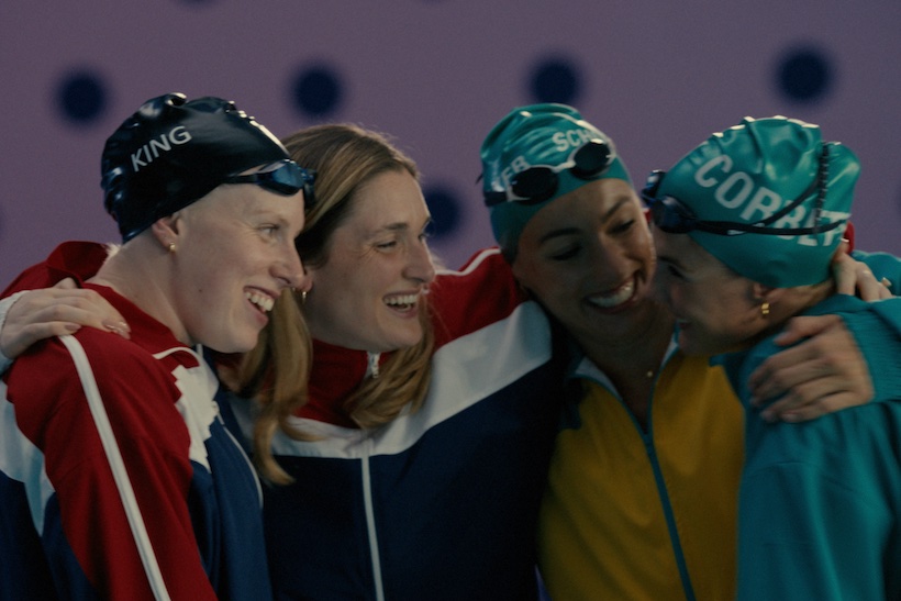 Group of Team USA Olympic swimmers hugging