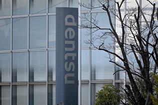 Dentsu logo in front of its company headquarters in Tokyo.