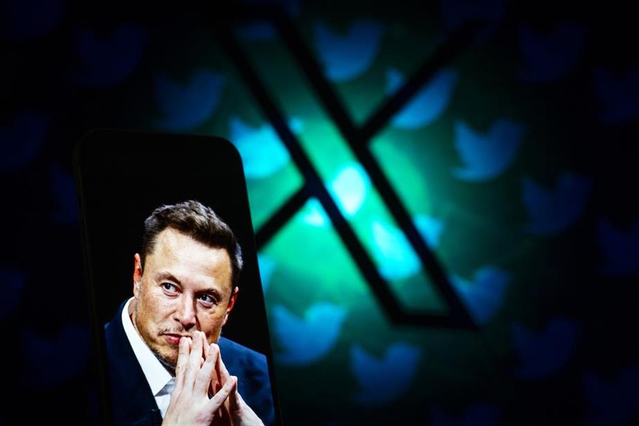 A mobile phone showing a picture of Elon Musk with a backgroun image of the X logo