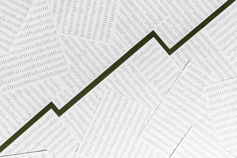 Sheets of paper arranged to create line graph in the center