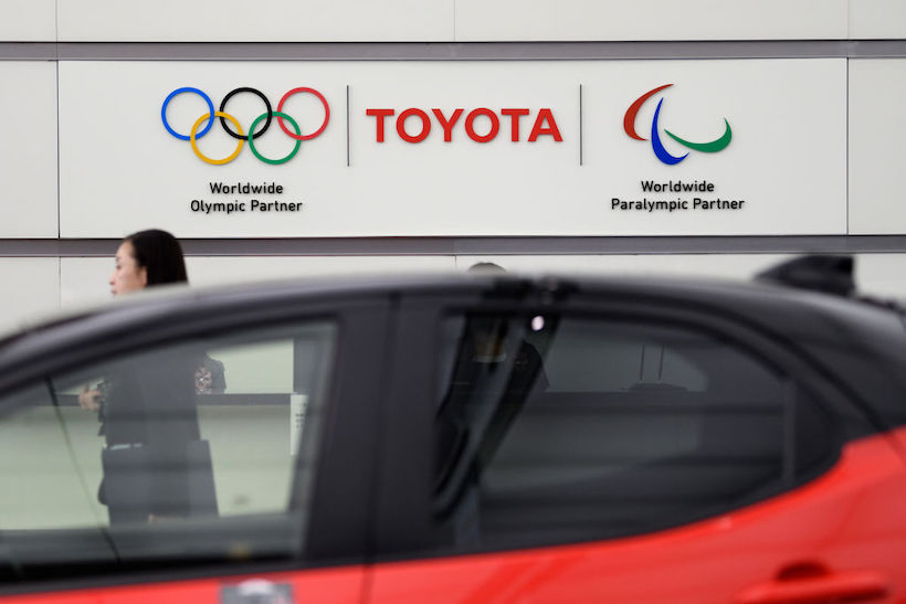 Signage for Toyota Motor Corp., center, the Olympic Games, left, and Paralympic Games are displayed at Toyota's Tokyo head office in Tokyo, Japan