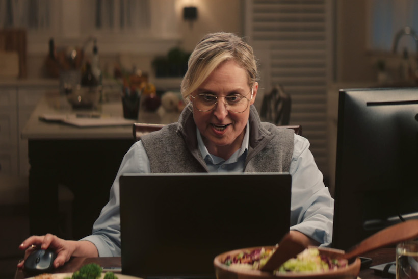 Woman using computer at home dinner table