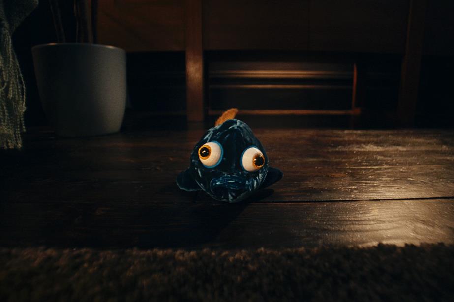 A toy fish lying on a floor