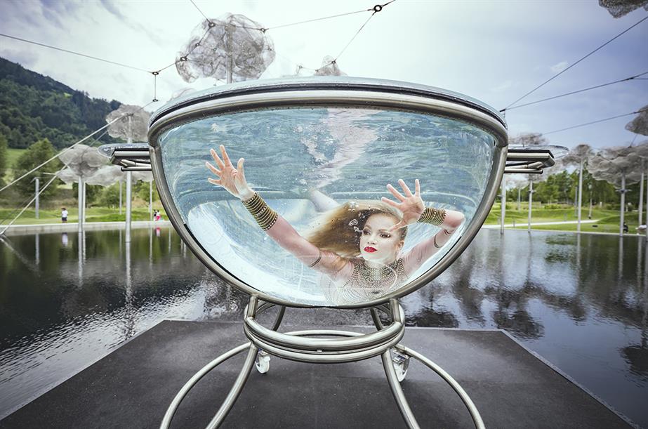 An acrobat performs water ballet in a 'crystal cloud' at Swarovski Crystal Worlds