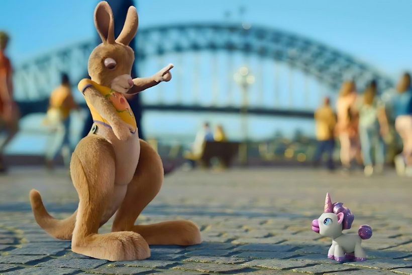 Screen shot of Tourism Australia G'Day campaign displaying puppet kangaroo and toy unicorn